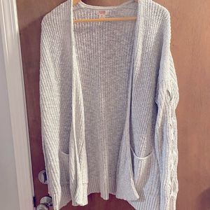 Gray knit cardigan with braid detail on the sleeves